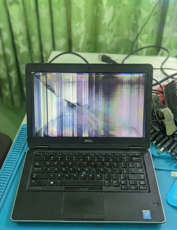 Dell laptop before display repair, with a broken screen